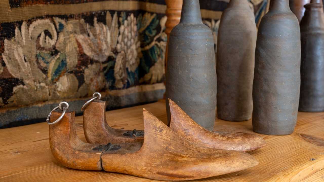 Lovely display of modern and antique memorabilia on a wooden table with ottoman beneath