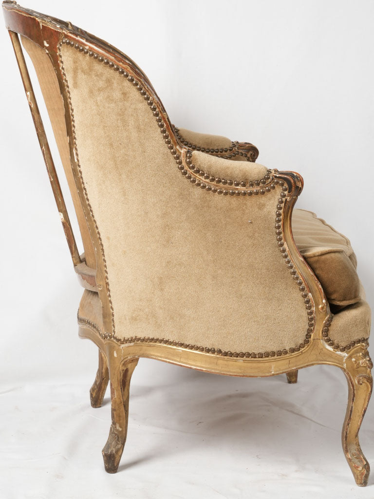 Time-worn gilded wood armchair