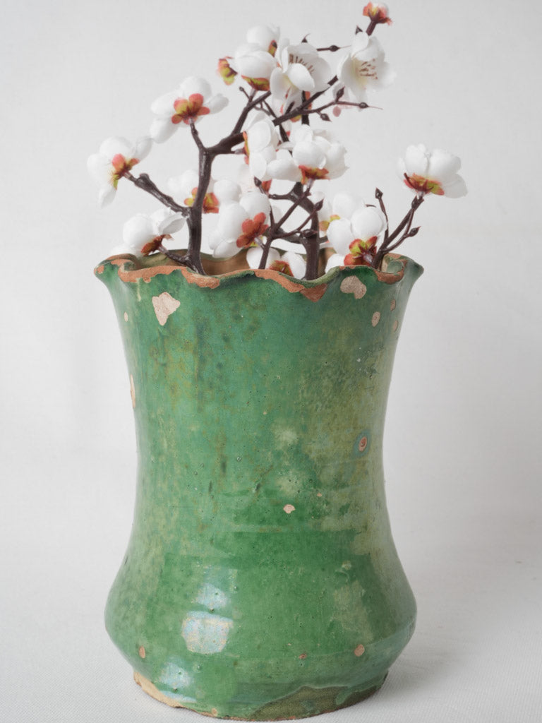 Aged, green glazed scalloped ceramic vase