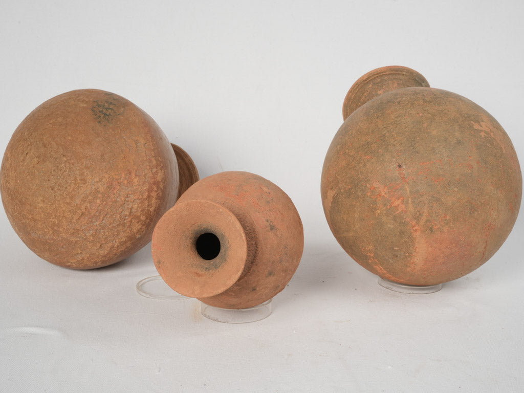 Weather-beaten terracotta funeral urns