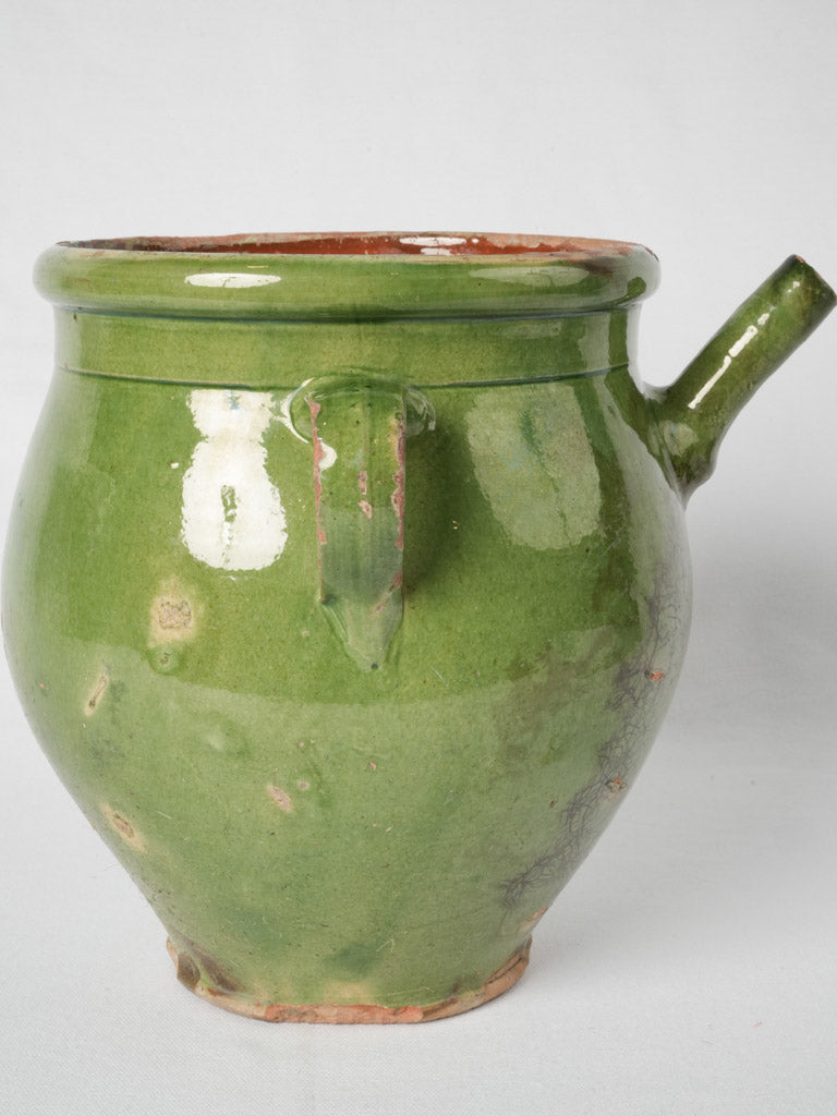 Antique terracotta pitcher with green glaze