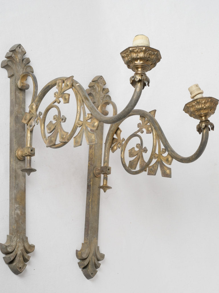 Aged brass fleur-de-lis sconces