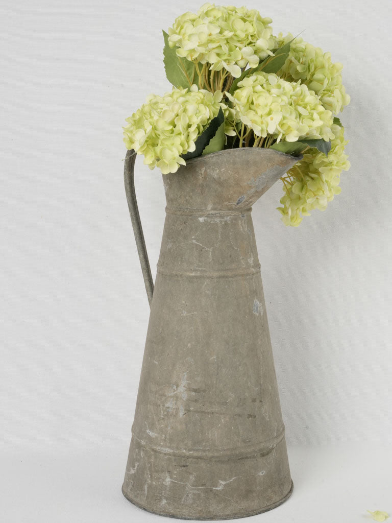 Aged farmhouse-style zinc pitcher