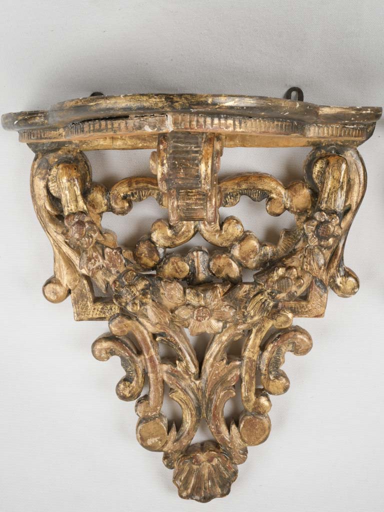 Intricate, gilded wall brackets