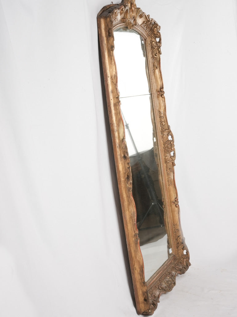 Age-spotted antique reflective wall mirror