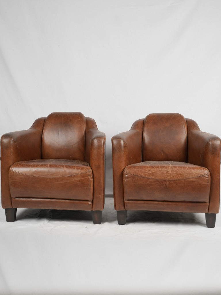 Elegant worn leather accent chairs