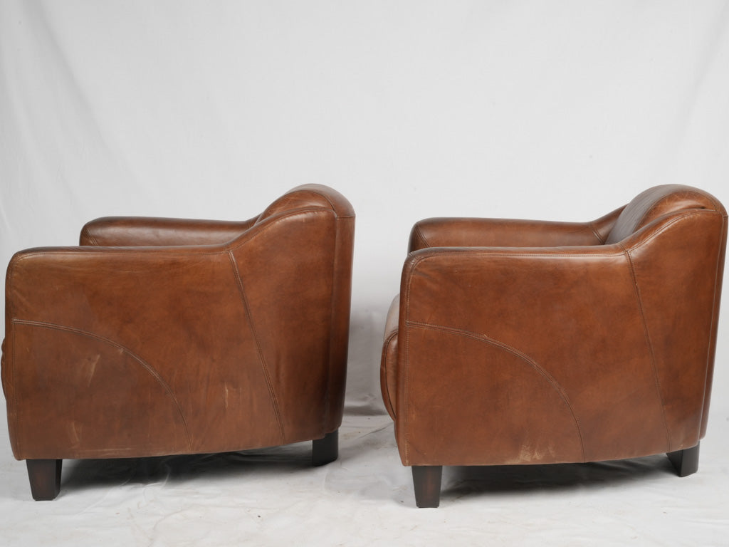 Worn patina vintage leather armchairs