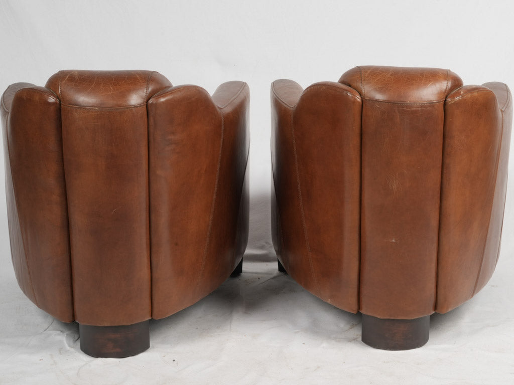 Distinctive aged leather club chairs