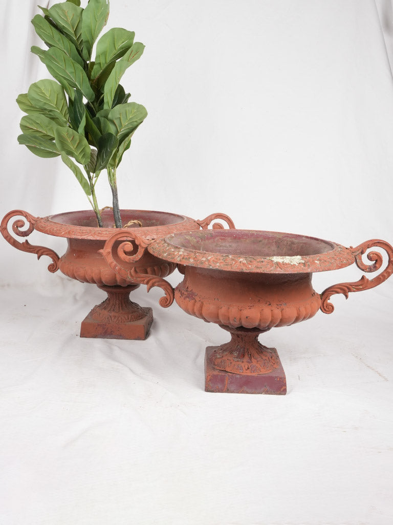 Antique red cast iron garden urns