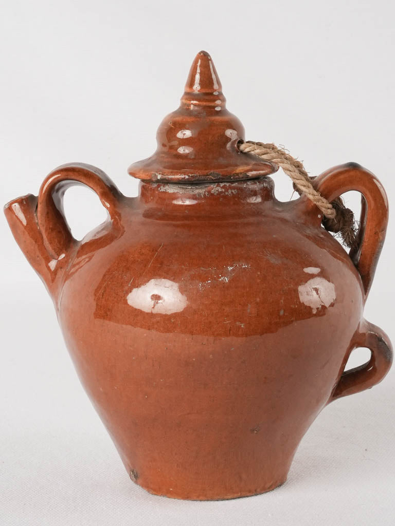 Old-fashioned triple-handled clay canteen