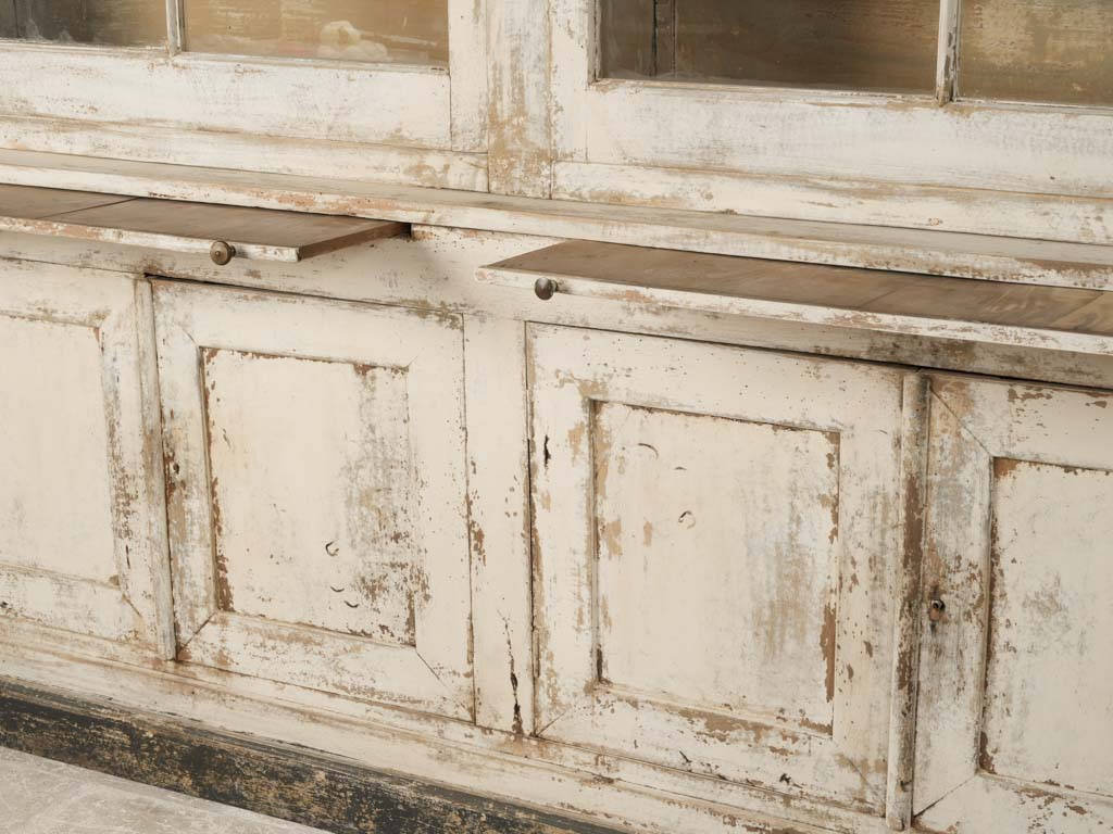 Aged, French country glass-door bookcase