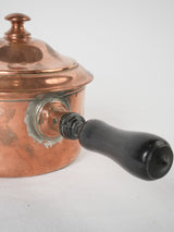 Vintage rustic copper cookware with wooden handle