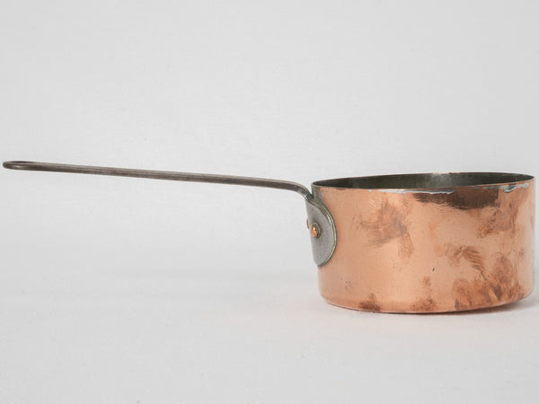 Vintage wrought iron-handled copper saucepan