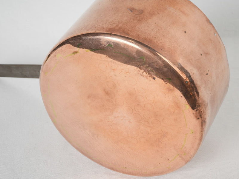 Handcrafted deep copper saucepan with ornate iron handle