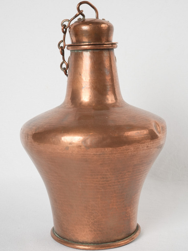 Aged amphora-style historical copper kettle