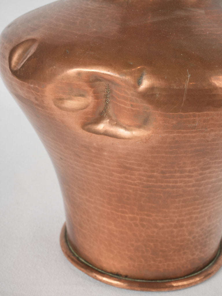 Old-fashioned hammered copper amphora cauquemar