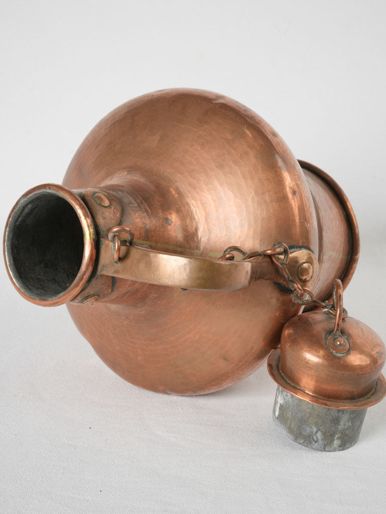 Time-worn antique copper amphora-shaped kettle