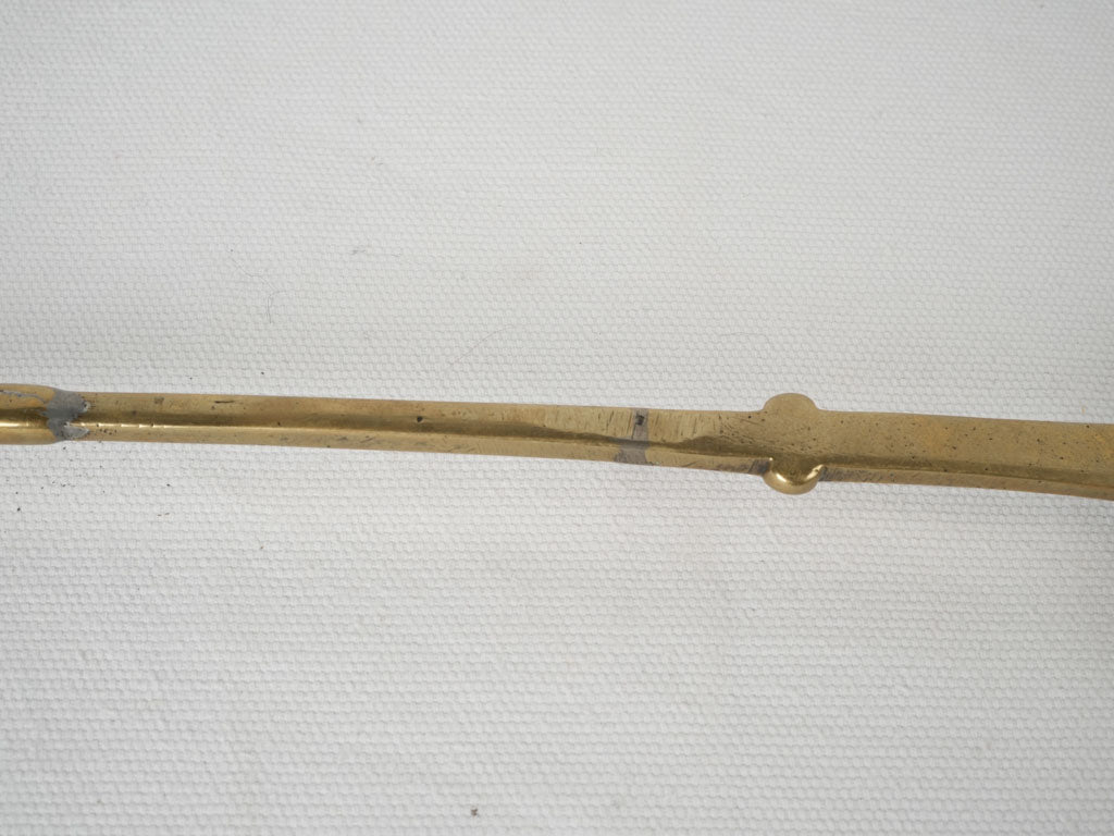 Historical brass hook-ended skimmer