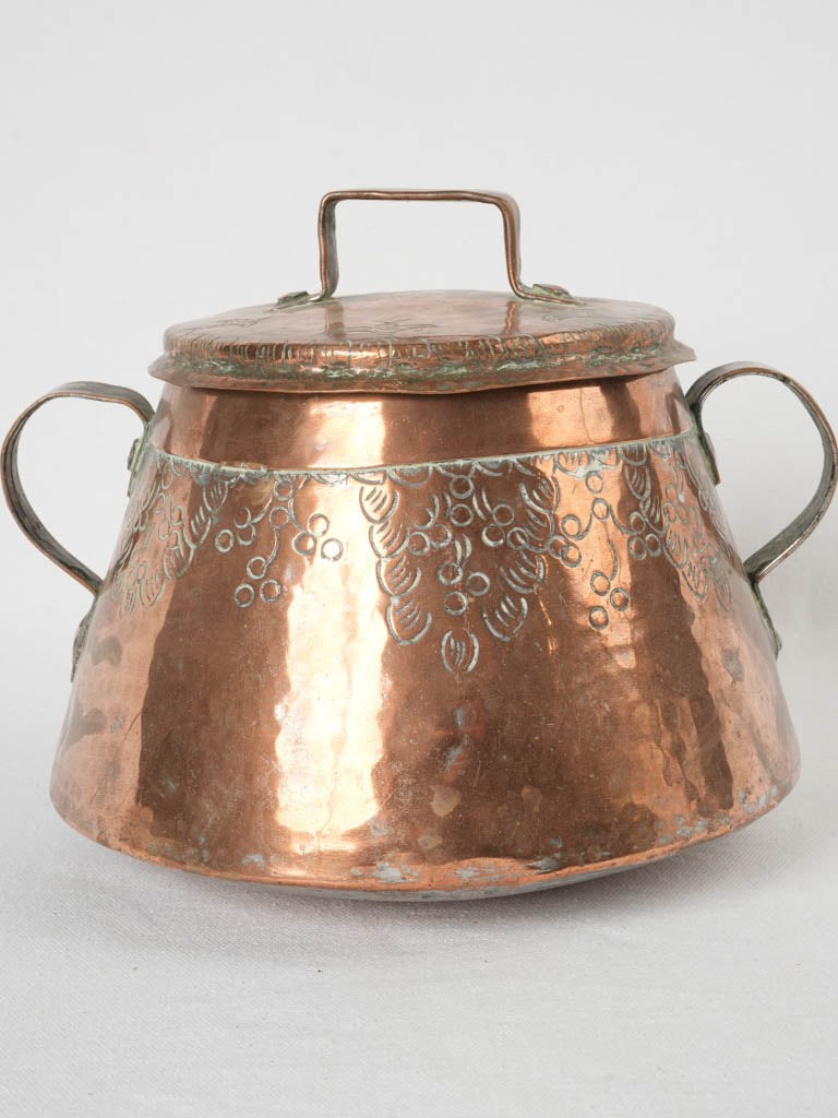 Intricately carved vintage copper pot