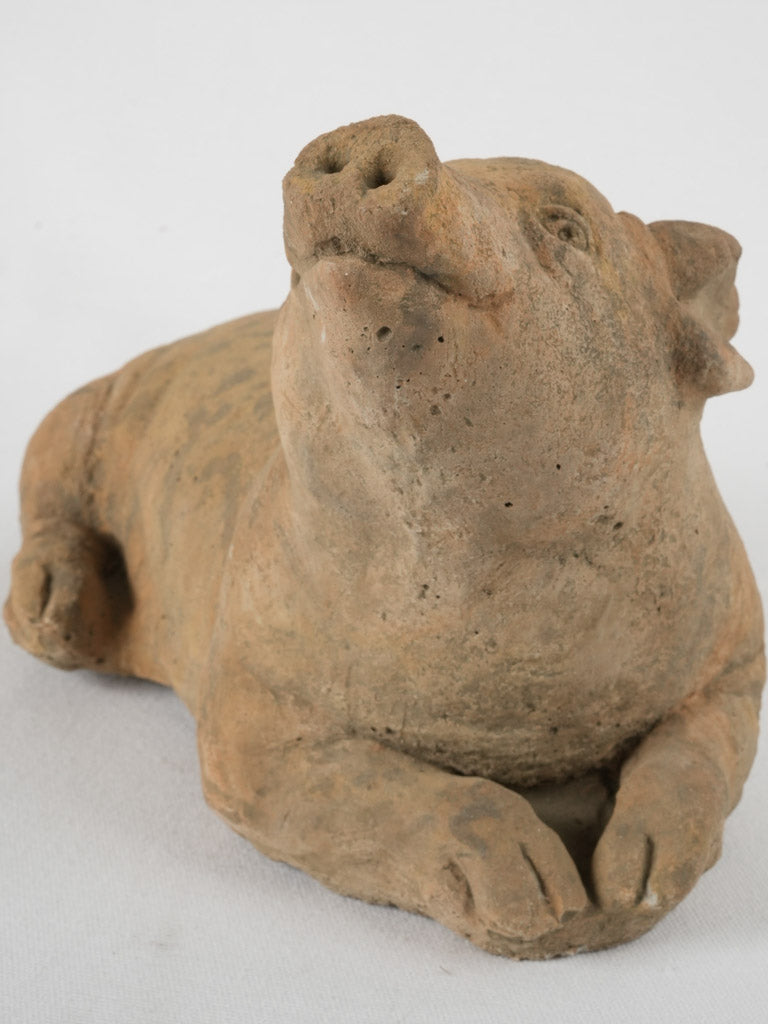 Adorable terracotta garden pig sculpture