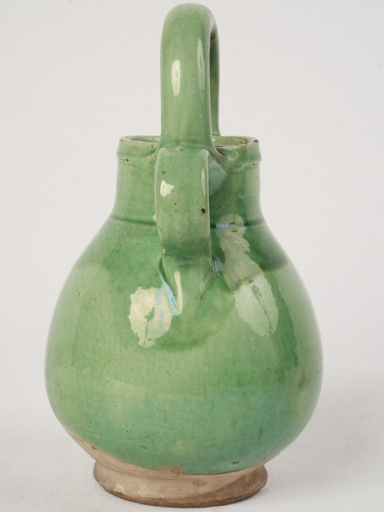 Delightful small green-glazed water jug