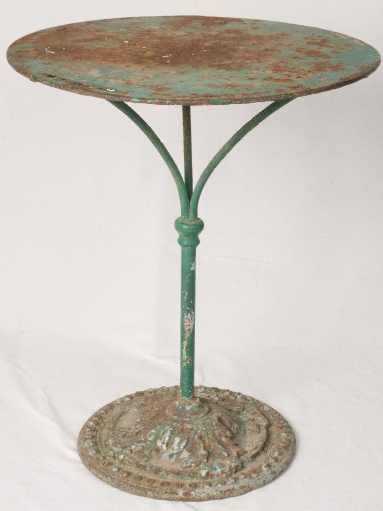 Aged, green-patina cast iron table