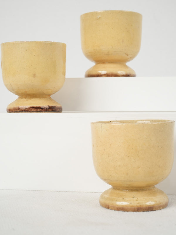 Charming vintage yellow-glazed ceramic egg cups