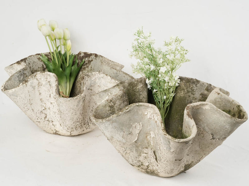 Weathered, vintage flower-shaped outdoor planters