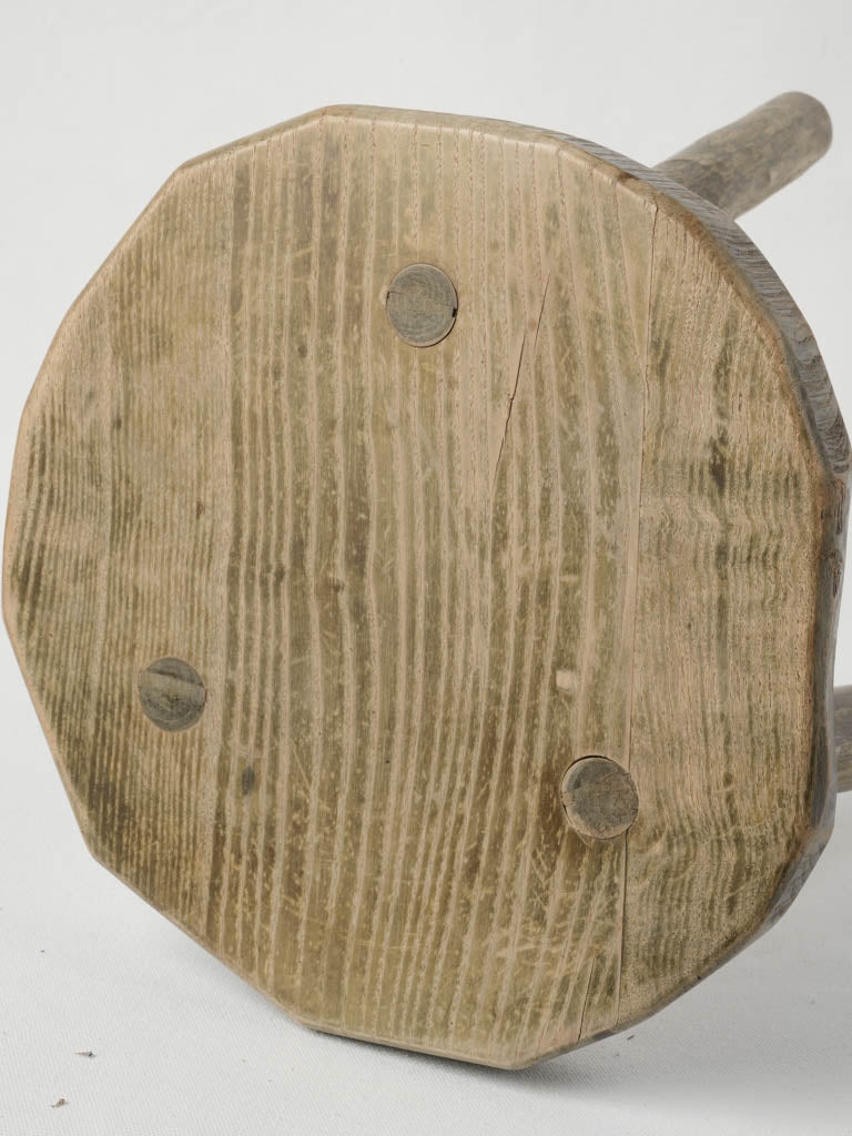 Aged wooden farm stool for sculpture