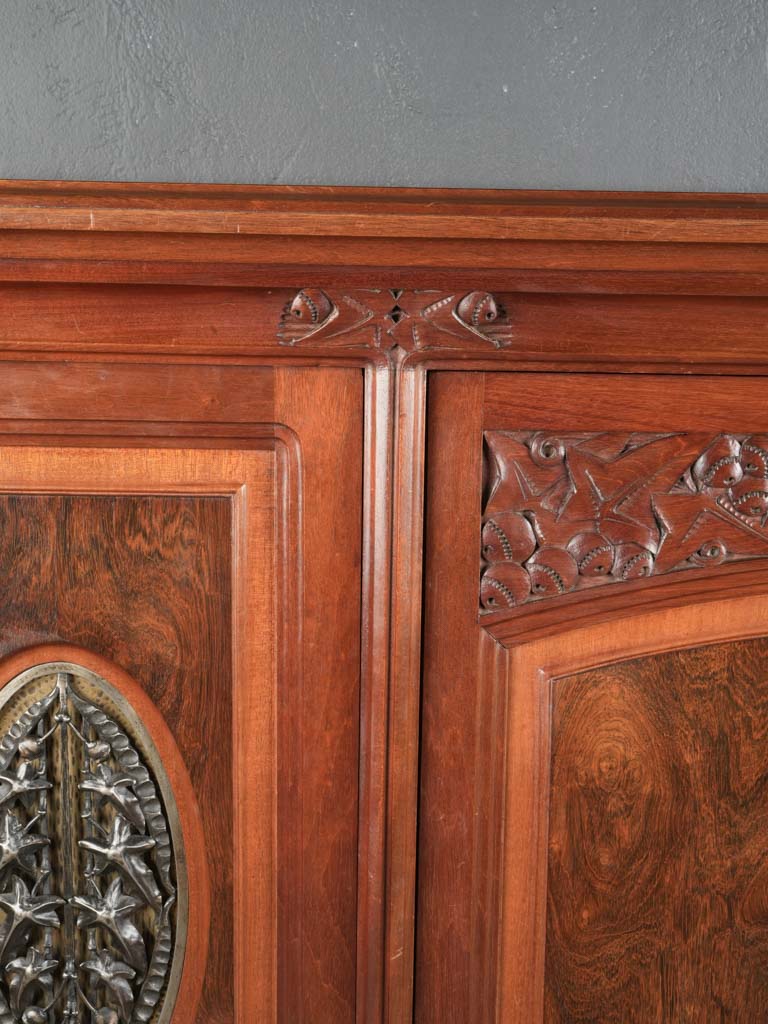 Intricate patinated iron motif cabinet