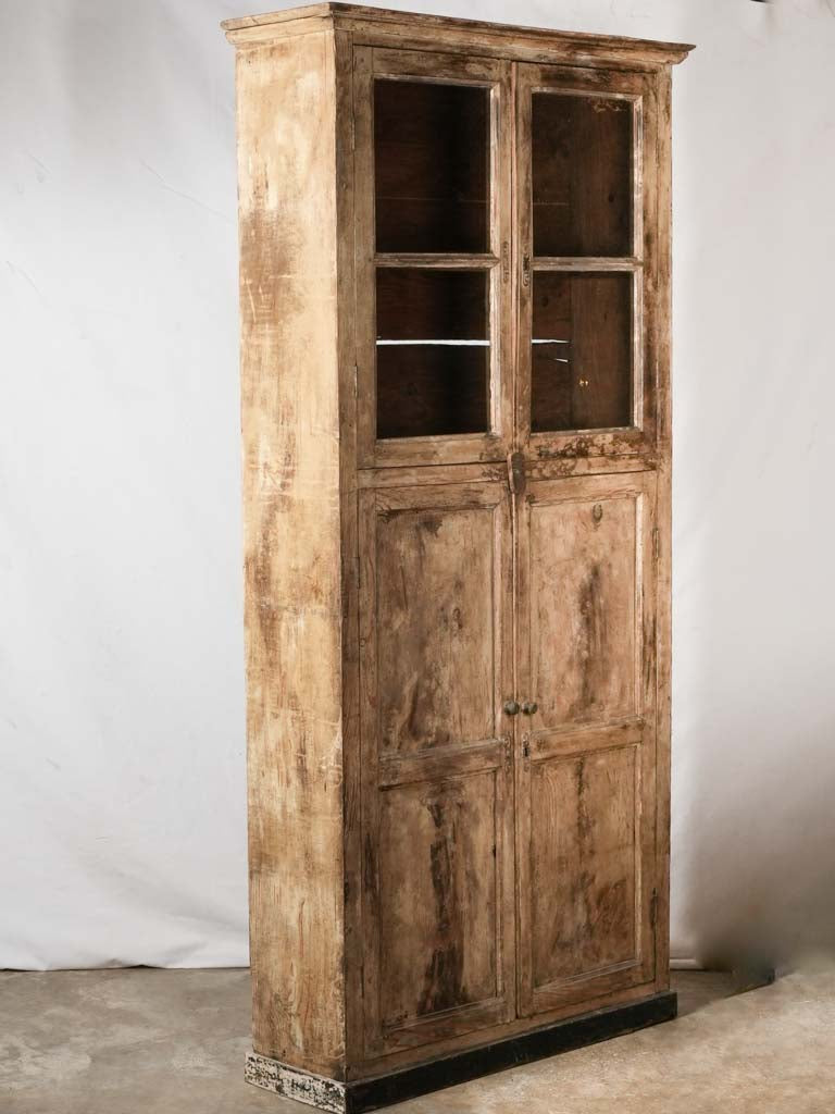 Vintage glass-paneled display armoire