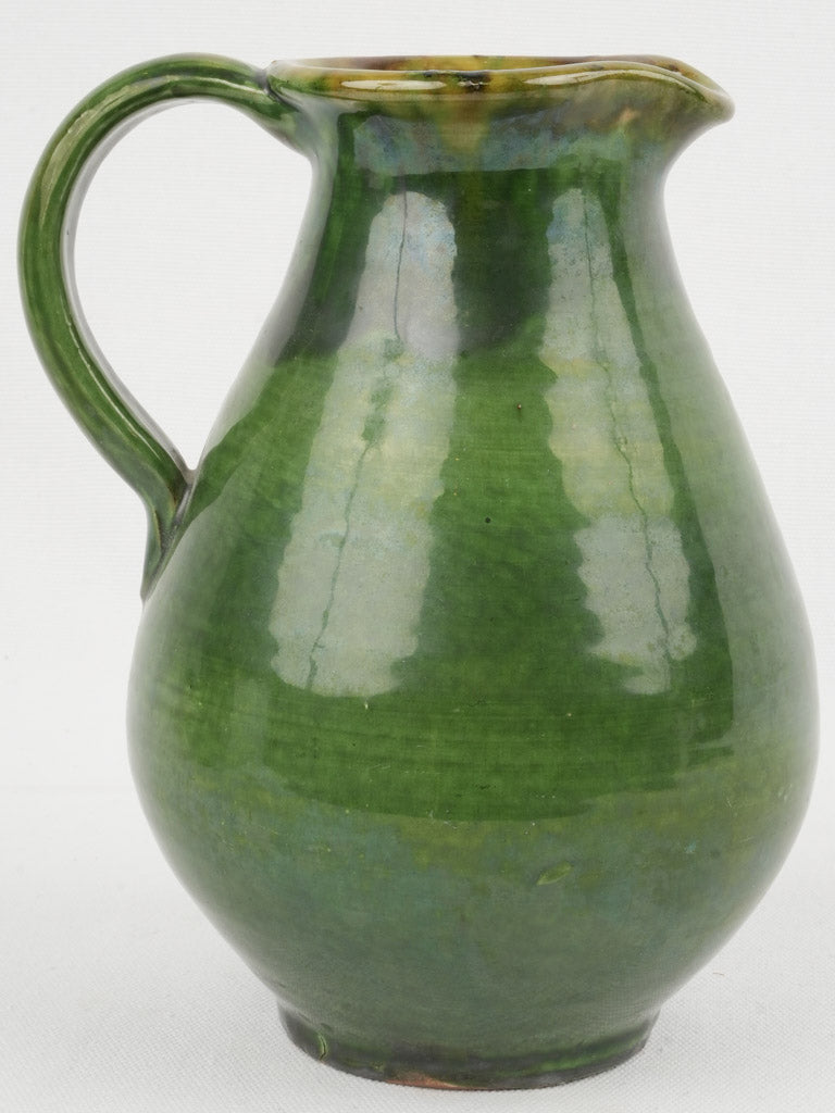 Organic, wide-mouthed, green-glazed pitcher