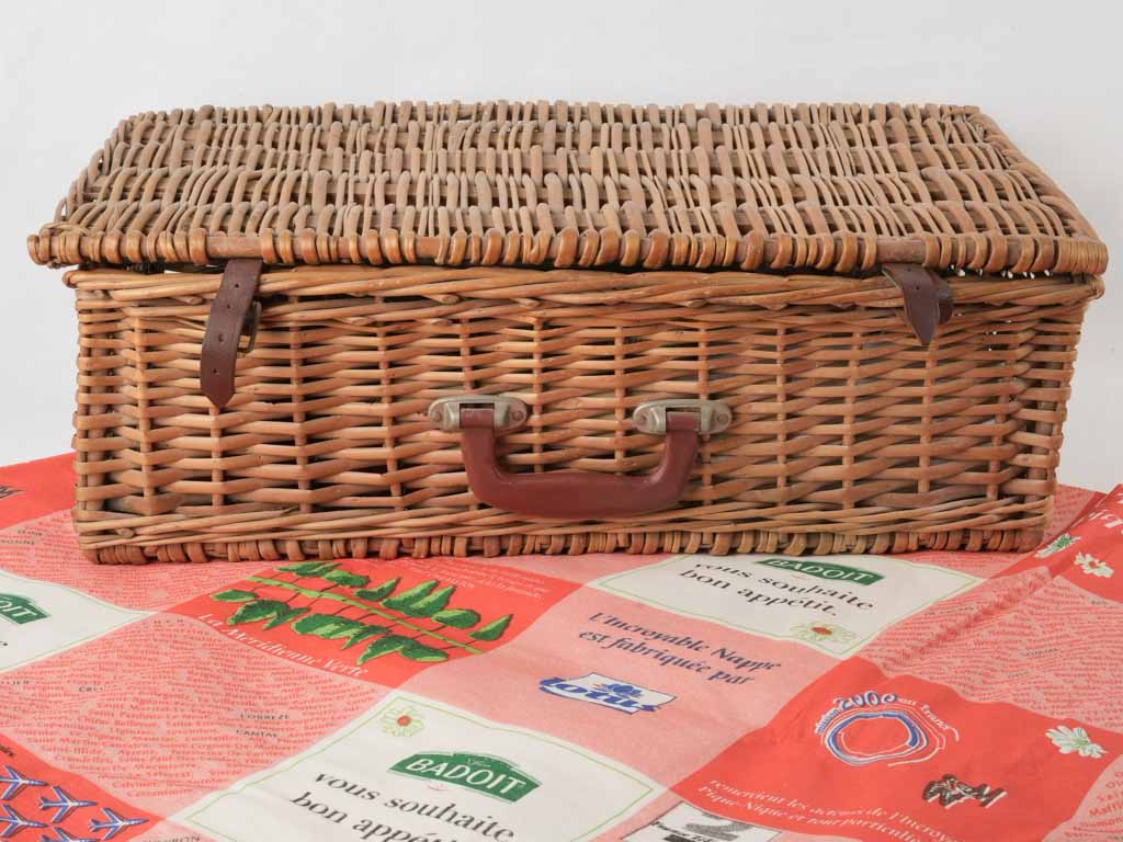 Traditional vintage picnic basket with tableware