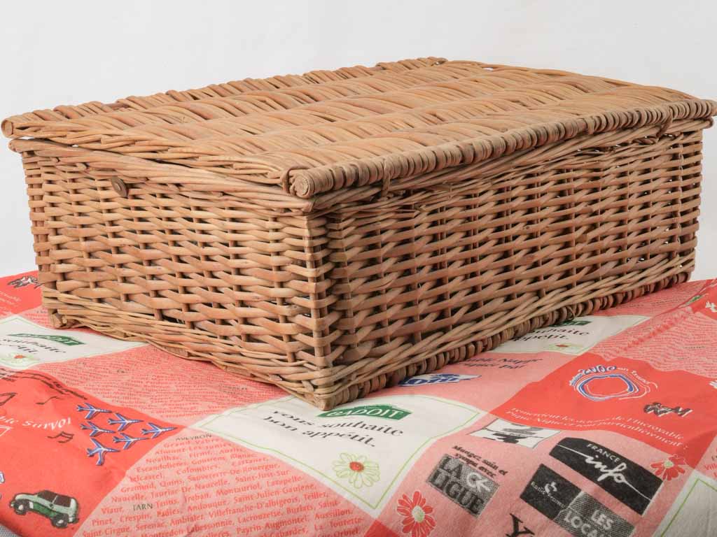 Stylish antique picnic basket with table setting