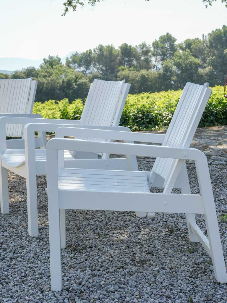 Elegant weathered white outdoor armchairs