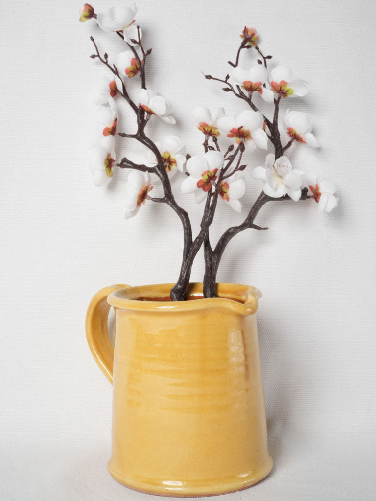 Rustic handmade ocher-glazed terracotta pitcher