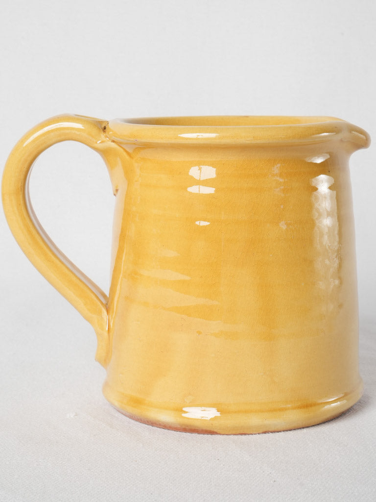 Artisanal ocher-glazed terracotta pitcher