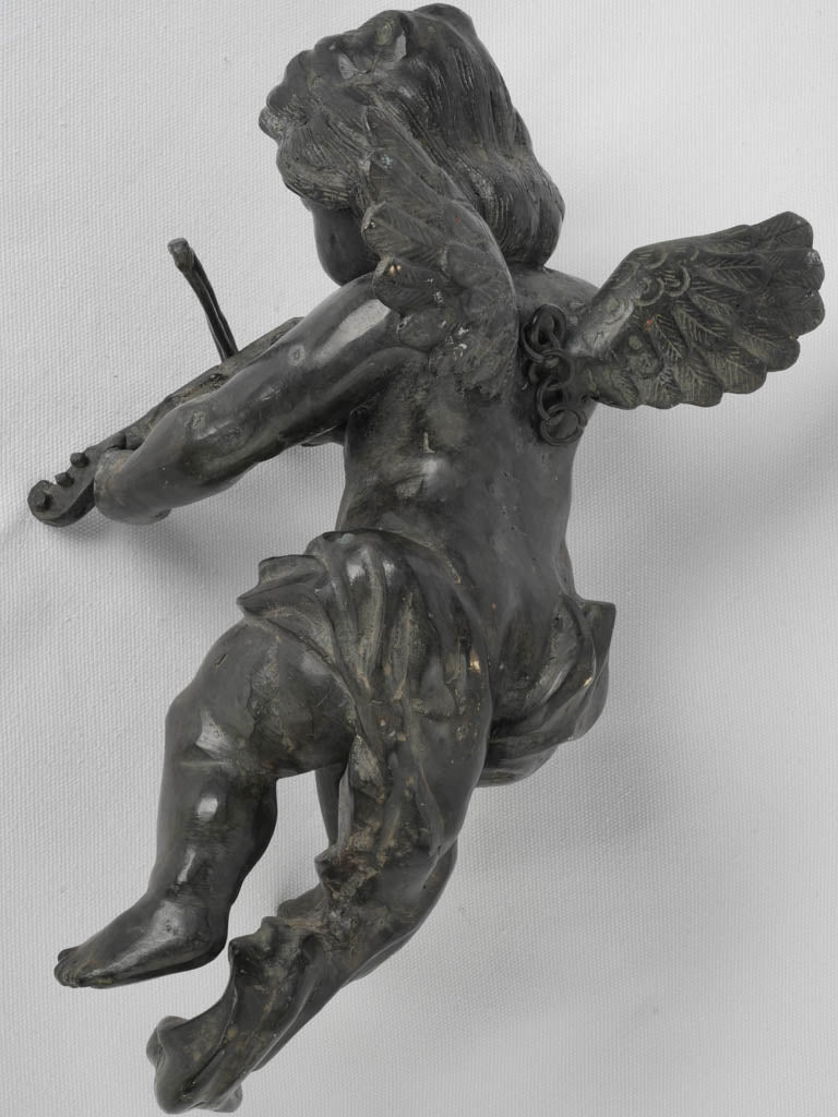 Ornate spelter cherub playing violin