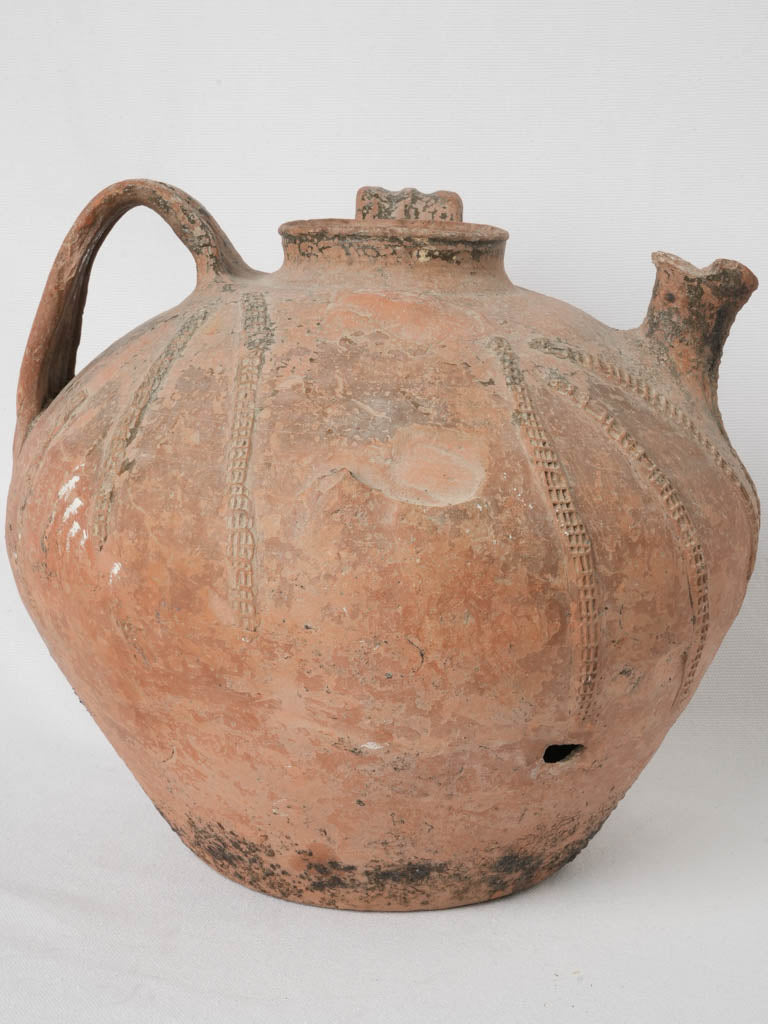 Time-worn terracotta water vessel