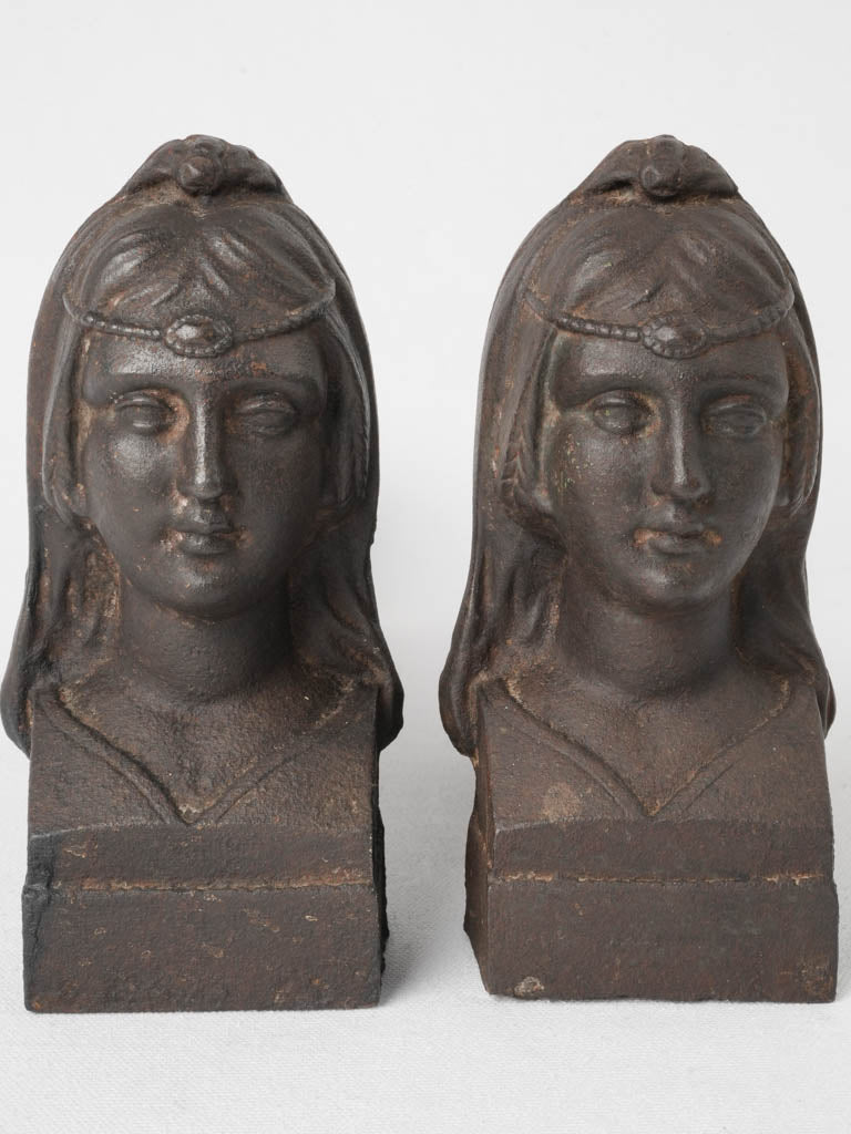 Aged Egyptian princess head firedogs