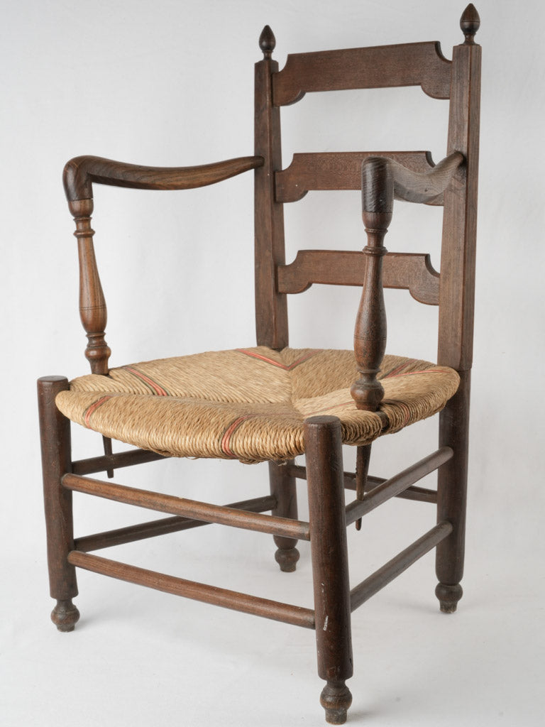 Aged wooden ladderback armchair