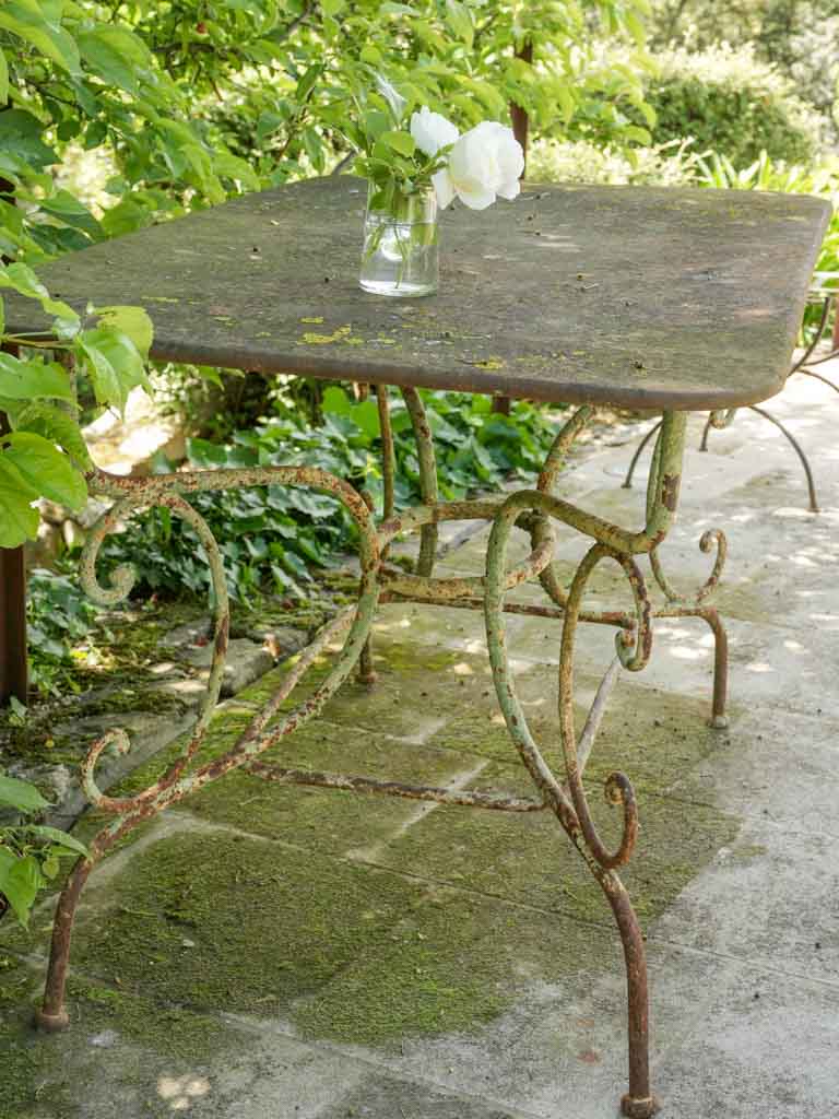 Aged wrought iron outdoor table