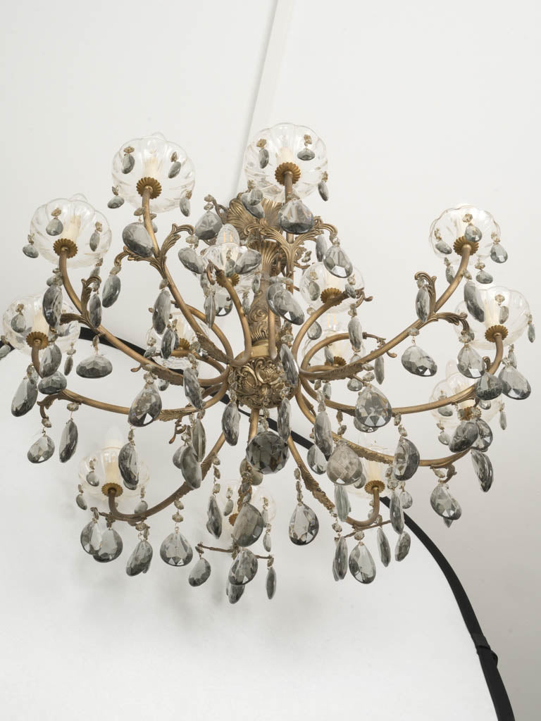 Smokey crystal adorned broad two-tiered chandelier