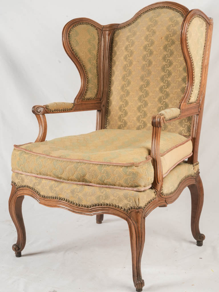 Antique French walnut wingback armchair