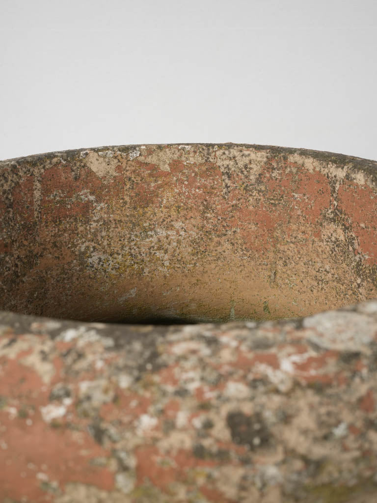 Time-worn terracotta round urn