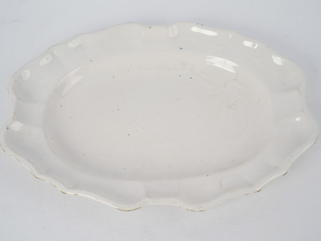 Scalloped, antique, ornate earthenware platter