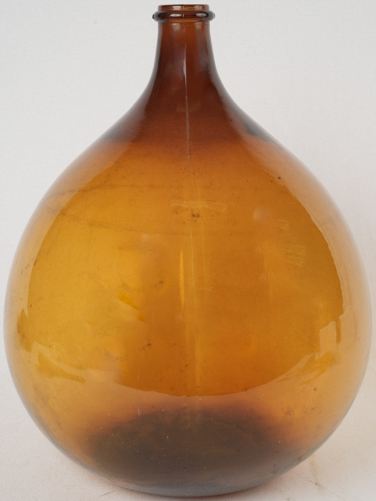 Vintage amber glass demijohn.