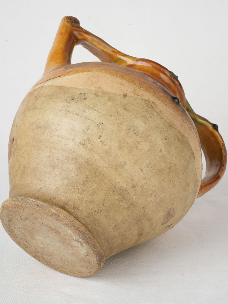 Artisanal ocher-green glazed jug