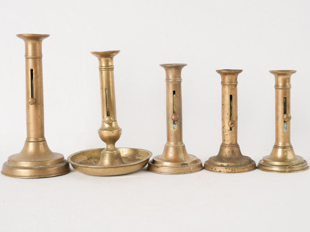 Historical lever-feature brass candlesticks