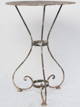 Antique double-braced iron floral table